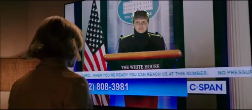 The scene from Pluribus where the President is holding a national news conference on C-SPAN just for Carol.  The president has been replaced with Anges Jurati as the Borg Collective queen.  The chyron reads "Carol, when you're ready, you can reach us at this number" and "No pressure".